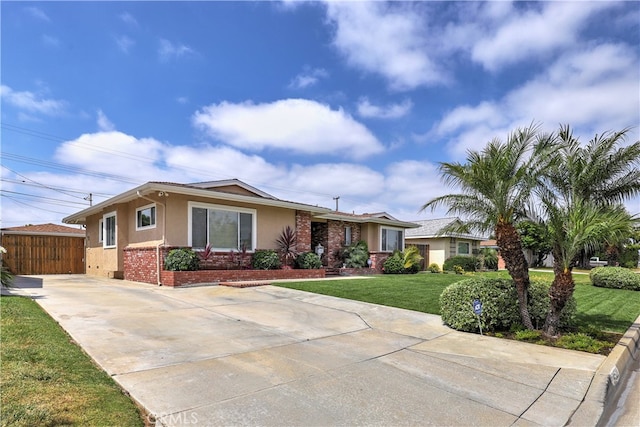 14522 San Feliciano Ln, Mirada, CA 90638 - ranch-style house with stucco siding, a front lawn, brick siding, and driveway
