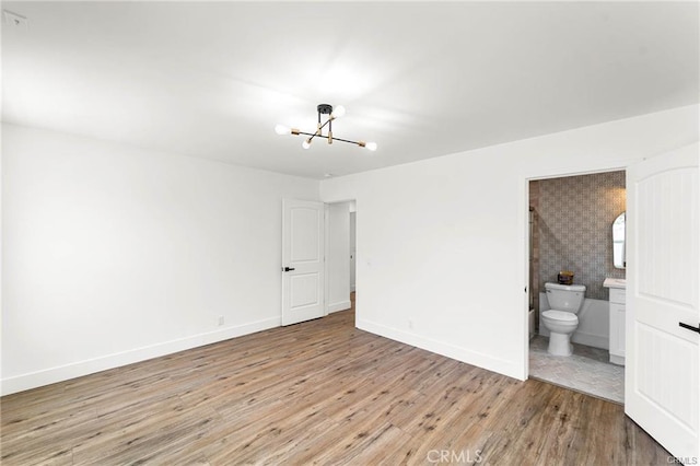 1144311445 Saticoy St, North Hollywood, CA 91605 - unfurnished bedroom featuring light wood-type flooring, a chandelier, baseboards, and connected bathroom