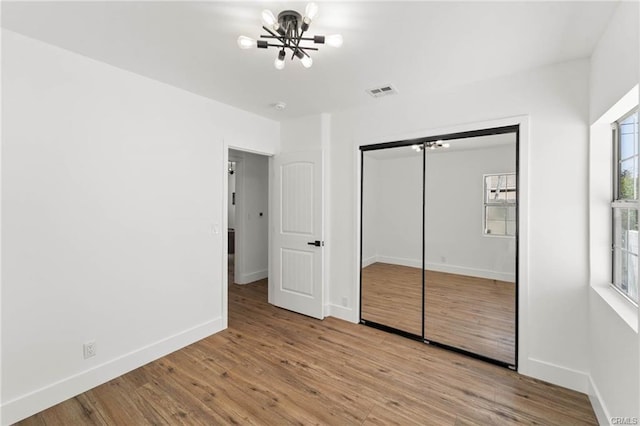 1144311445 Saticoy St, North Hollywood, CA 91605 - unfurnished bedroom featuring a chandelier, wood finished floors, baseboards, and a closet
