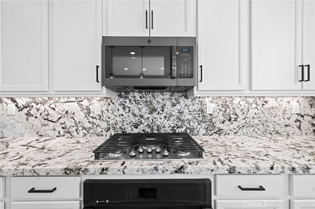 32129 Dymondia Way, Temecula, CA 92591 - kitchen with black microwave, stainless steel gas stovetop, white cabinets, backsplash, and oven