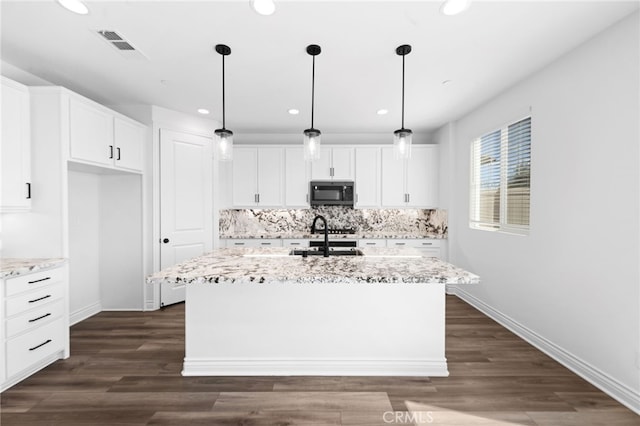 32129 Dymondia Way, Temecula, CA 92591 - kitchen with recessed lighting, an island with sink, backsplash, baseboards, and white cabinetry