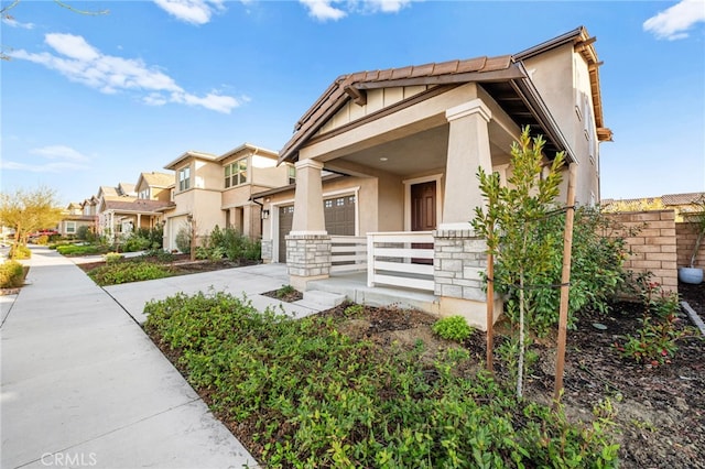 32129 Dymondia Way, Temecula, CA 92591 - view of front of home with concrete driveway, an attached garage, stucco siding, stone siding, and covered porch