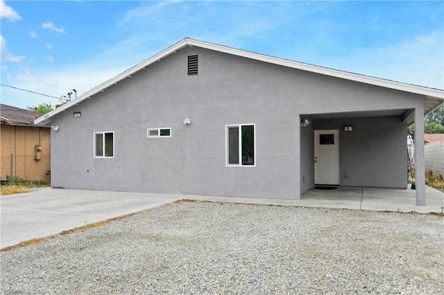 1467 W Olive St, San Bernardino, CA 92411 - back of house with stucco siding and a patio area