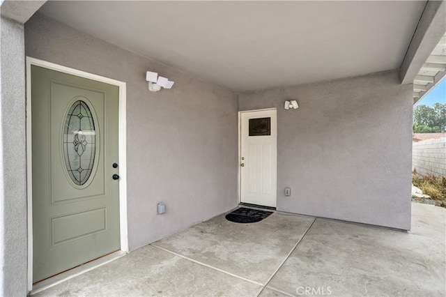1467 W Olive St, San Bernardino, CA 92411 - view of exterior entry featuring stucco siding and a patio area