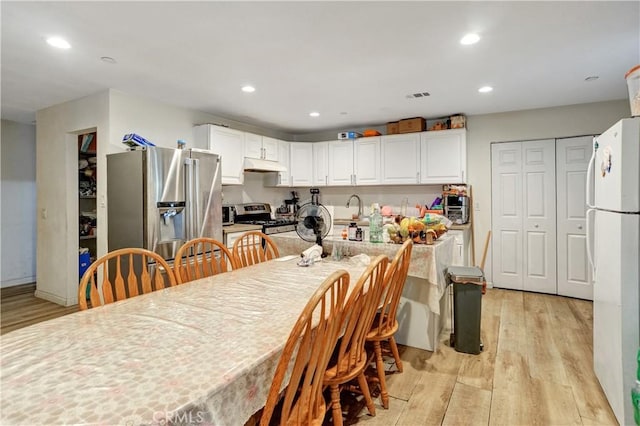 1467 W Olive St, San Bernardino, CA 92411 - dining room featuring light wood-type flooring and recessed lighting