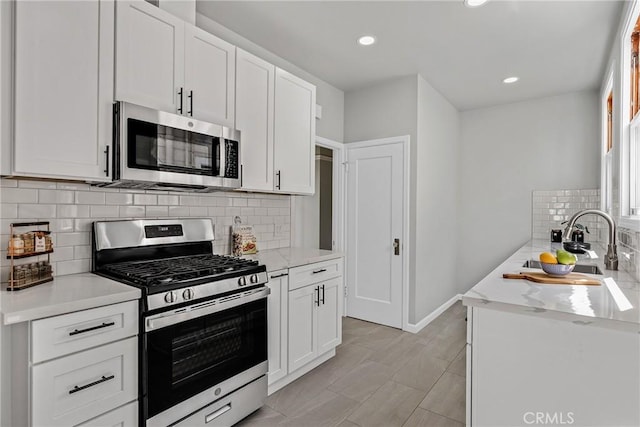 874 41st Ave, San Francisco, CA 94121 - kitchen featuring stainless steel appliances, white cabinetry, backsplash, recessed lighting, and baseboards