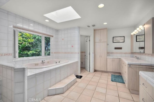 1801 Laurel Ave, Manhattan Beach, CA 90266 - full bathroom with a skylight, a tub with jets, tile patterned floors, vanity, and recessed lighting