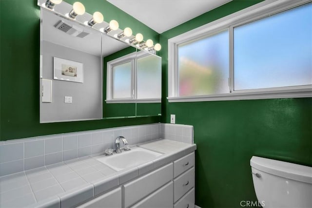 1801 Laurel Ave, Manhattan Beach, CA 90266 - bathroom featuring vanity, toilet, and decorative backsplash