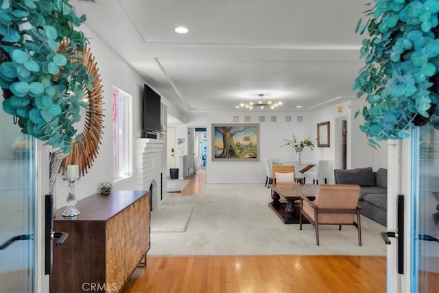 1801 Laurel Ave, Manhattan Beach, CA 90266 - entryway featuring a fireplace, a chandelier, and light wood-style floors