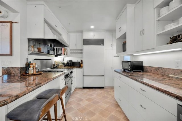 1801 Laurel Ave, Manhattan Beach, CA 90266 - kitchen featuring high quality appliances, recessed lighting, dark stone countertops, and white cabinetry