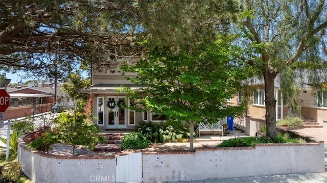 1801 Laurel Ave, Manhattan Beach, CA 90266 - obstructed view of property featuring french doors, a fenced front yard, and a gate