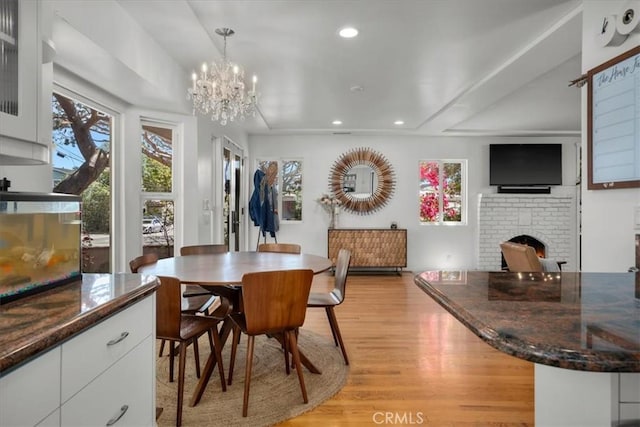 1801 Laurel Ave, Manhattan Beach, CA 90266 - dining space featuring plenty of natural light, a fireplace, light wood finished floors, recessed lighting, and a chandelier