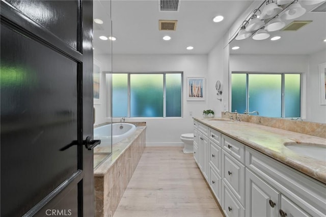 14332 Roblar Pl, Sherman Oaks, CA 91423 - bathroom featuring double vanity, toilet, a bath, wood finished floors, and recessed lighting