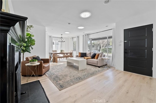 14332 Roblar Pl, Sherman Oaks, CA 91423 - living room featuring a fireplace, light wood finished floors, a chandelier, and recessed lighting