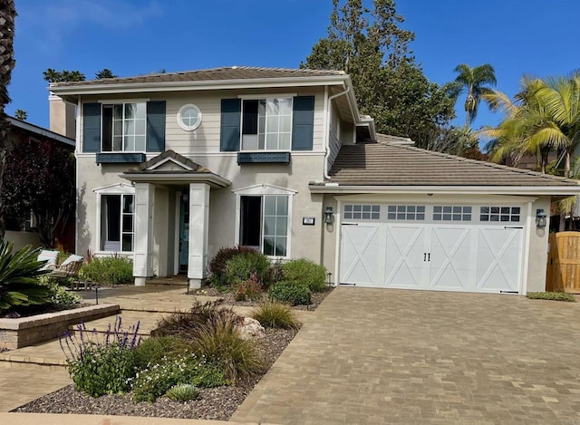 283 Rain Tree Dr, Encinitas, CA 92024 - view of front of property with stucco siding, decorative driveway, an attached garage, and a tile roof