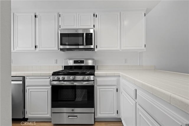 1188 Via Montoya, Camarillo, CA 93010 - kitchen featuring appliances with stainless steel finishes, tile countertops, and white cabinetry