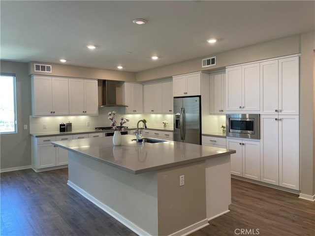 187 Bowery, Irvine, CA 92612 - kitchen with stainless steel appliances, wall chimney range hood, a sink, dark wood-style floors, and recessed lighting