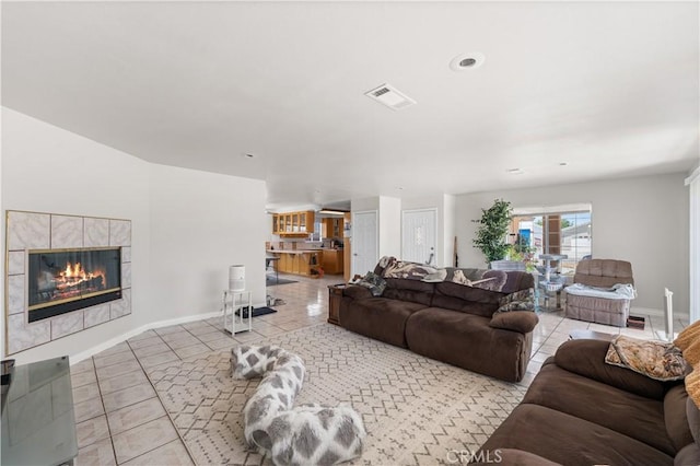 9824 Evelyn Ave, California City, CA 93505 - living area with tile patterned flooring, a fireplace, and baseboards