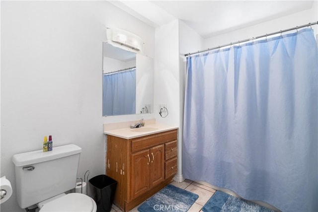 9824 Evelyn Ave, California City, CA 93505 - full bathroom with toilet, vanity, tile patterned floors, and a shower with shower curtain