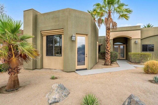 74158 Pele Pl, Palm Desert, CA 92211 - view of front of home with stucco siding and french doors
