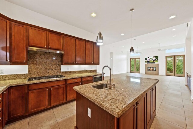 74158 Pele Pl, Palm Desert, CA 92211 - kitchen featuring a sink, stainless steel gas cooktop, under cabinet range hood, light tile patterned floors, and tasteful backsplash