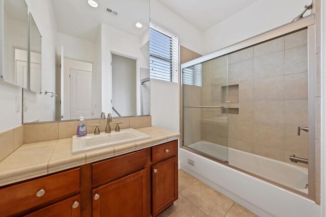 74158 Pele Pl, Palm Desert, CA 92211 - full bathroom featuring vanity, bath / shower combo with glass door, and tile patterned flooring