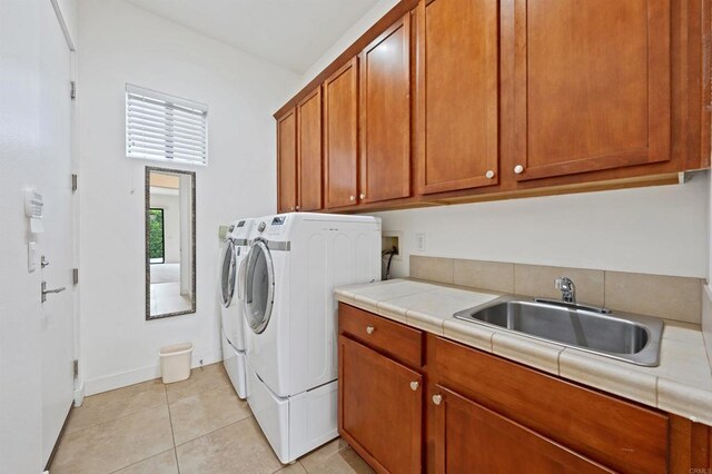 74158 Pele Pl, Palm Desert, CA 92211 - washroom with cabinet space, independent washer and dryer, light tile patterned flooring, and baseboards
