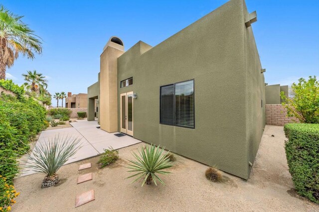 74158 Pele Pl, Palm Desert, CA 92211 - back of property featuring stucco siding and a patio
