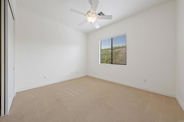 74158 Pele Pl, Palm Desert, CA 92211 - empty room featuring light carpet, baseboards, and ceiling fan