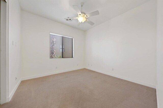 74158 Pele Pl, Palm Desert, CA 92211 - spare room with light carpet, baseboards, and ceiling fan