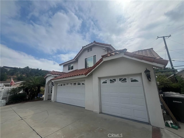 2445 N Santiago Blvd, Orange, CA 92867 - view of home's exterior featuring a tiled roof, stucco siding, concrete driveway, and an attached garage