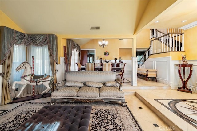 2445 N Santiago Blvd, Orange, CA 92867 - living room with a chandelier, inlaid floor details, stairs, a wainscoted wall, and a decorative wall