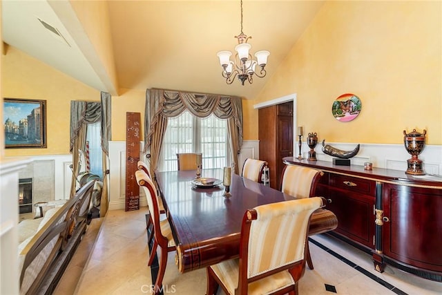 2445 N Santiago Blvd, Orange, CA 92867 - dining space with a chandelier, a wainscoted wall, light tile patterned flooring, high vaulted ceiling, and a decorative wall