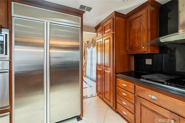 2445 N Santiago Blvd, Orange, CA 92867 - kitchen with appliances with stainless steel finishes, range hood, dark countertops, light tile patterned floors, and brown cabinetry