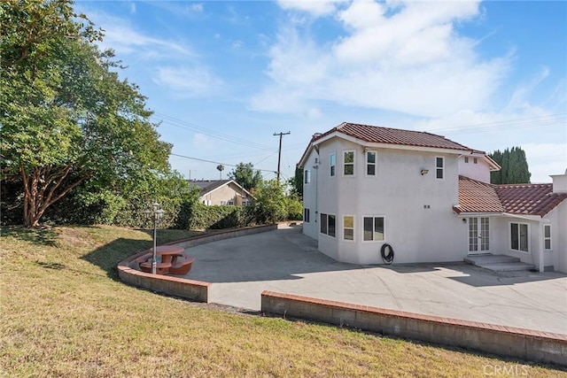 2445 N Santiago Blvd, Orange, CA 92867 - rear view of property featuring a patio area, a tiled roof, stucco siding, and a lawn