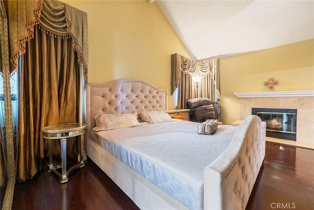 2445 N Santiago Blvd, Orange, CA 92867 - bedroom featuring wood finished floors, vaulted ceiling, and a premium fireplace