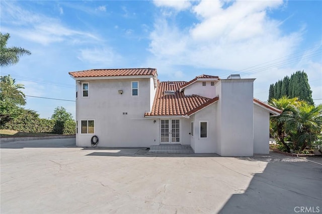 2445 N Santiago Blvd, Orange, CA 92867 - rear view of house featuring a tile roof, stucco siding, a patio area, and french doors
