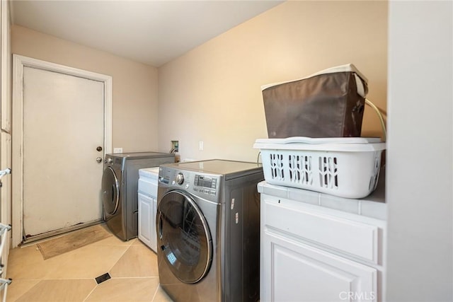 2445 N Santiago Blvd, Orange, CA 92867 - washroom with cabinet space, washer and dryer, and light tile patterned flooring