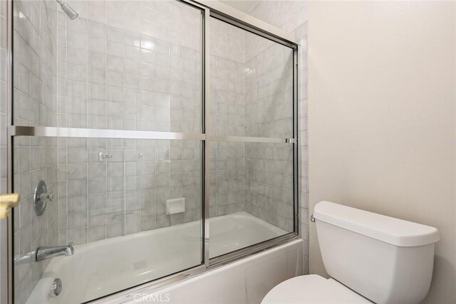 2445 N Santiago Blvd, Orange, CA 92867 - bathroom featuring toilet and bath / shower combo with glass door