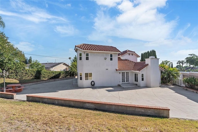 2445 N Santiago Blvd, Orange, CA 92867 - back of house with a patio, a tile roof, stucco siding, and a chimney