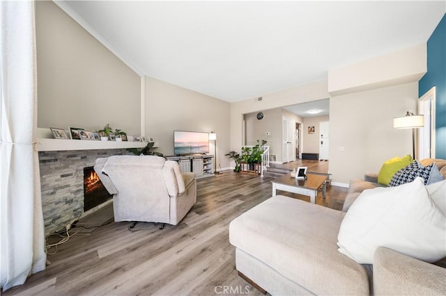 11 Palos Unit 55, Irvine, CA 92612 - living room featuring wood finished floors, a fireplace, and baseboards