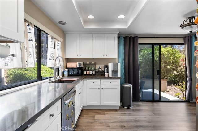 11 Palos Unit 55, Irvine, CA 92612 - kitchen with stainless steel dishwasher, a sink, a raised ceiling, white cabinets, and recessed lighting