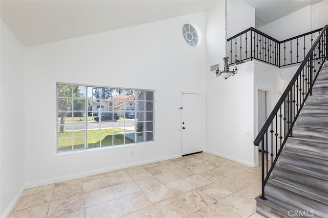 28705 Bridge Water Ln, Menifee, CA 92584 - entryway featuring high vaulted ceiling, stairs, and a chandelier