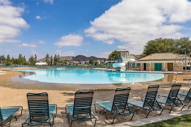 28705 Bridge Water Ln, Menifee, CA 92584 - community pool with a water slide, a mountain view, and a patio area