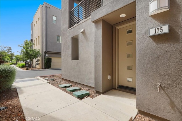 175 Cadence, Irvine, CA 92618 - doorway to property featuring stucco siding