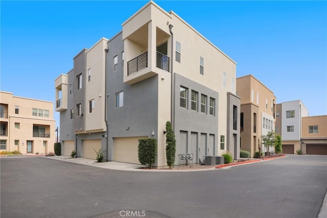 175 Cadence, Irvine, CA 92618 - view of building exterior featuring central air condition unit, an attached garage, and a residential view