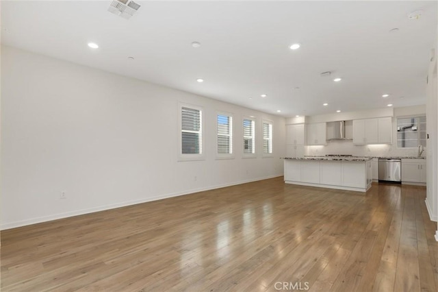 175 Cadence, Irvine, CA 92618 - unfurnished living room with light wood-type flooring, recessed lighting, baseboards, and a sink