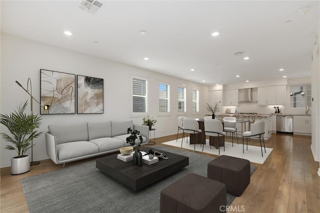 175 Cadence, Irvine, CA 92618 - living room featuring light wood-style floors, recessed lighting, and baseboards