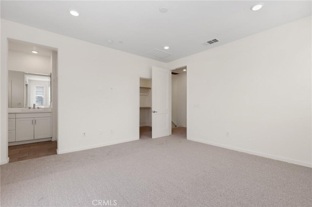 175 Cadence, Irvine, CA 92618 - unfurnished bedroom featuring carpet, recessed lighting, a walk in closet, baseboards, and connected bathroom
