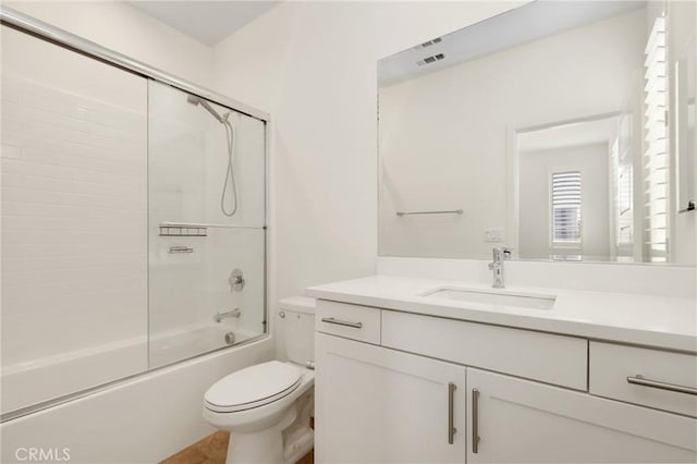 175 Cadence, Irvine, CA 92618 - bathroom featuring toilet, vanity, and shower / bath combination with glass door